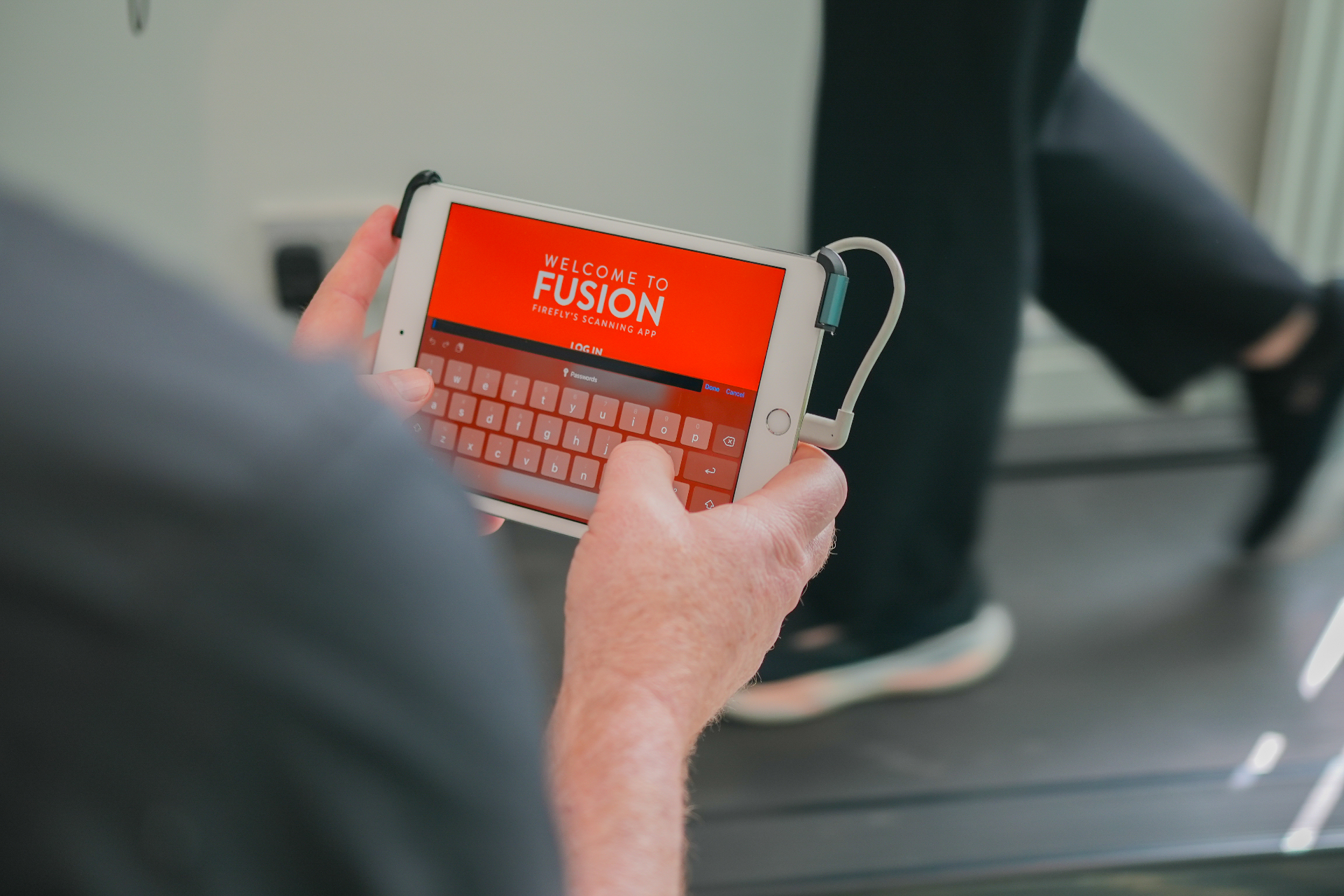 Podiatrist using Firefly Fusion gait analysis scanning app on a tablet during a treadmill assessment at Instep Footcare