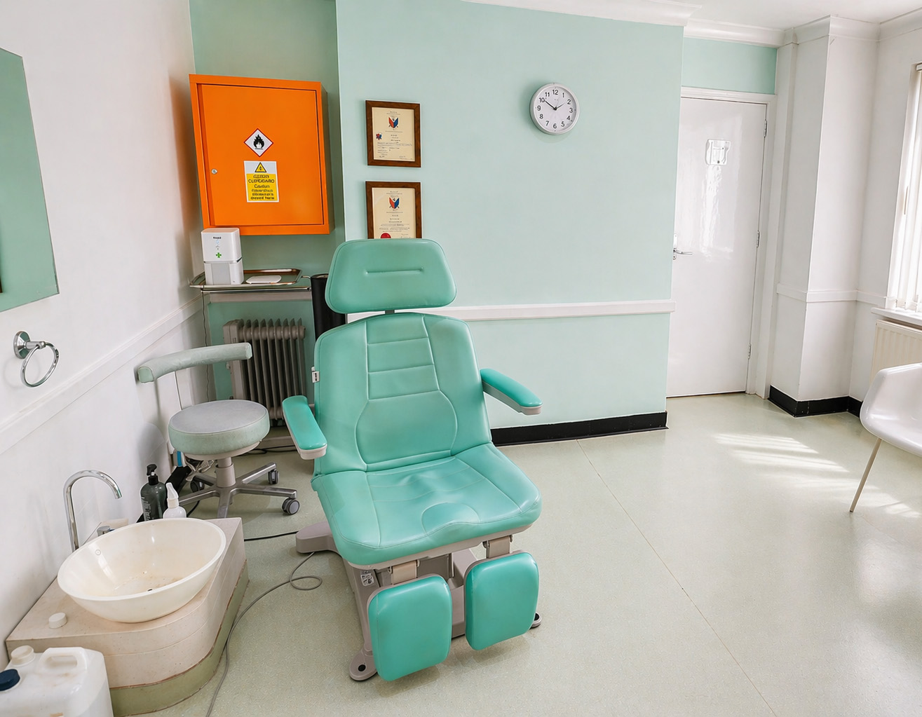 Treatment room at Instep Footcare with podiatry chair and certifications